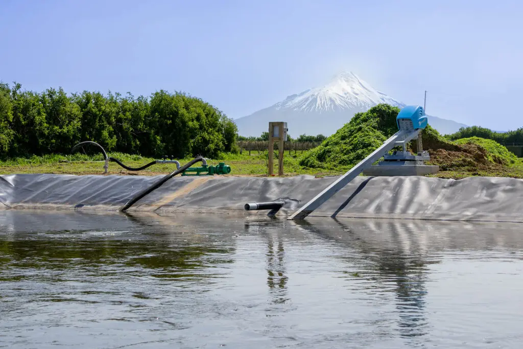 How Often Should an Effluent Pond be Stirred? 2 Nevada Electric Stirrer and PC Pump on shore of a lined pond with Maunga Taranaki in the background