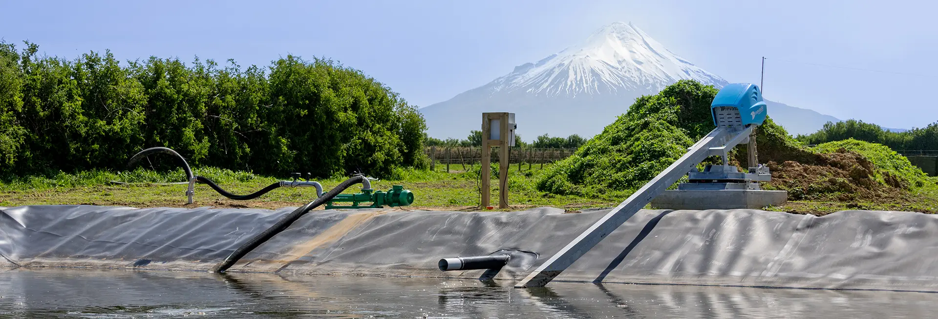 Nevada Hero Progress Cavity Effluent pump on side of pond with Electric Stirrer and Taranaki Maunga in background