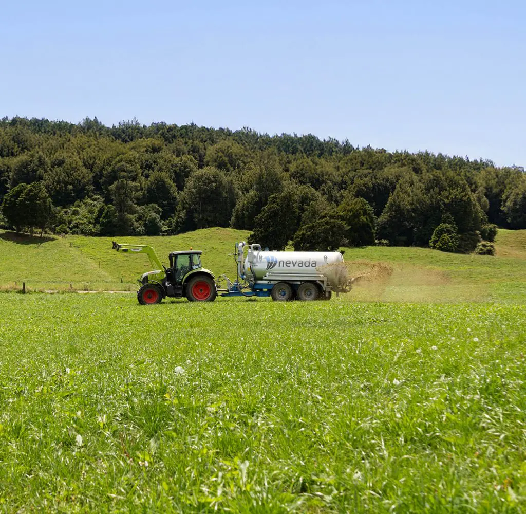 Nevada 12,800L Tandem Slurry Tanker spreading effluent over a healthy pasture with a Rainwave applicator