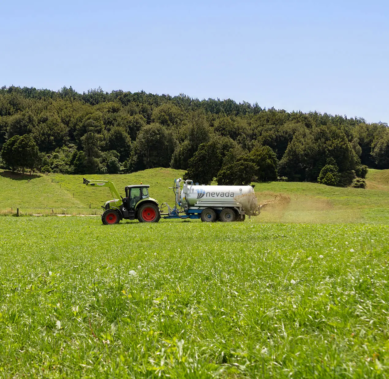 Nevada 12,800L Tandem Slurry Tanker spreading effluent over a healthy pasture with a Rainwave applicator