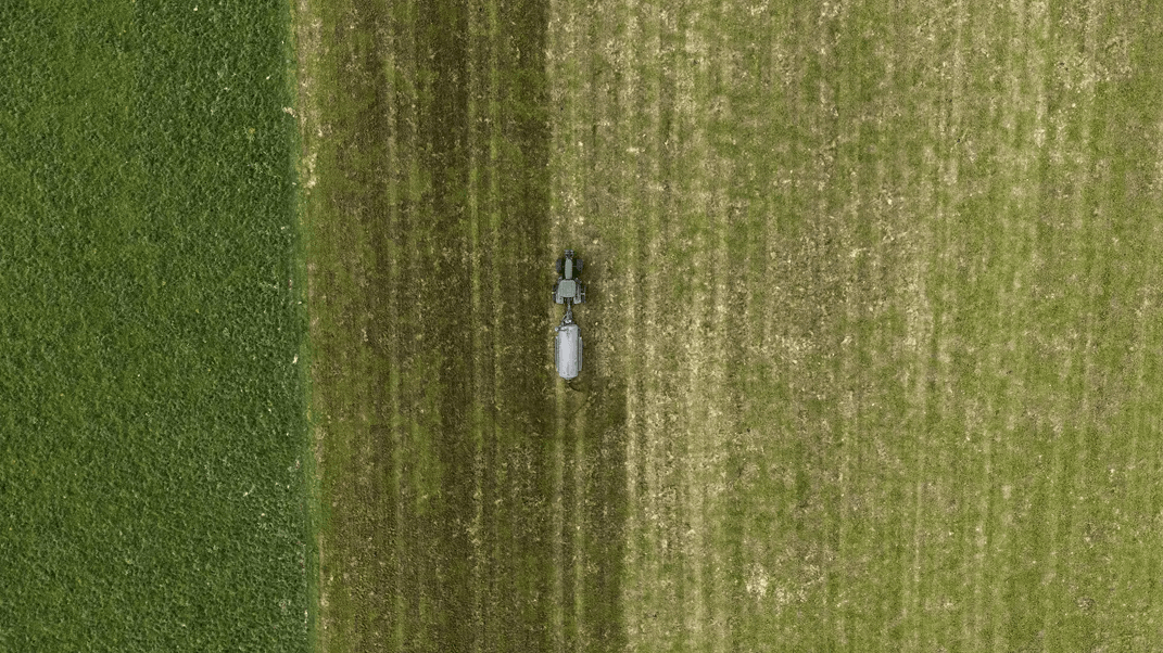Fabian Pereira farms in the heart of the Waikato 1 Nevada 12,800L Tandem Axle Slurry Tanker spreading effleunt onto a paddock top view from drone