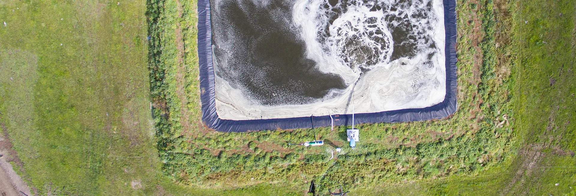 Aerial of an effluent pond being stirred with a Nevada Electric Stirrer
