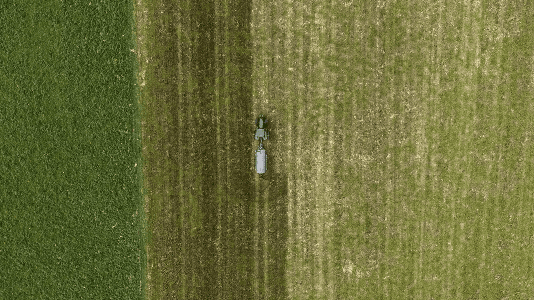 Nevada 12,800L Tandem Axle Slurry Tanker spreading effleunt onto a paddock top view from drone